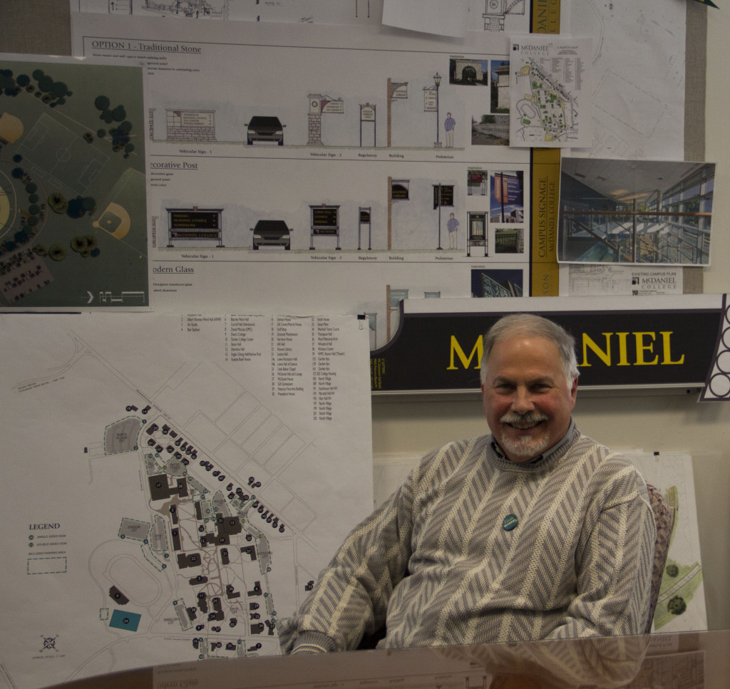 Seidel sits in his conference room, showing off the plans for expanding North Village and adding more signage to campus.