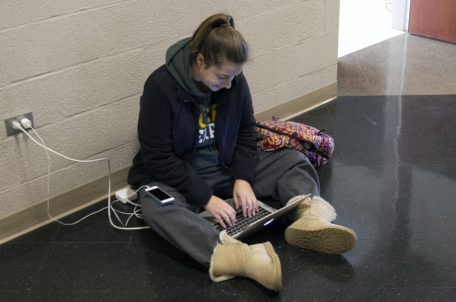 Lindsay Rothrock charges her laptop while Lewis had power for students to use.