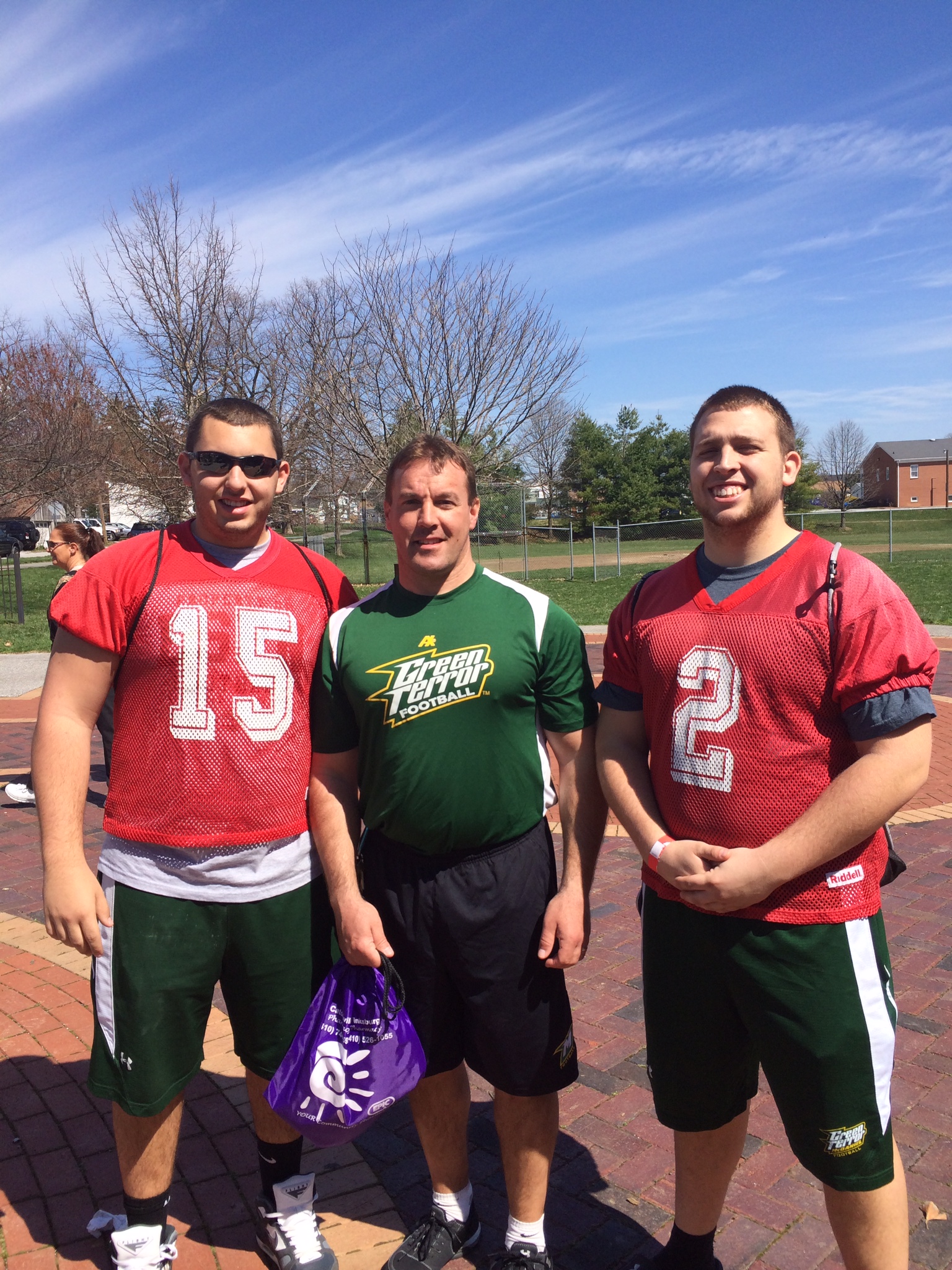 McDaniel Football kickers Ryan Lutes (left) and Douglass MacArthur (right) with Head Coach, Mike Hoyt (middle) at start of walk of Walk A Mile in Her Shoes at Dutterer Family Park in Westminster, MD