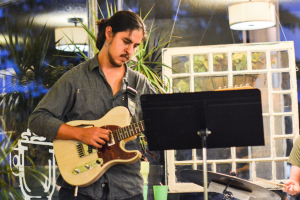 Eron plays guitar during his group's performance. Photo by Kyle Parks. 