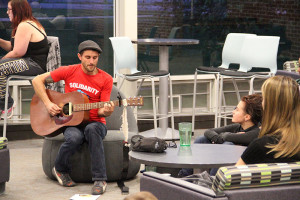 Harvey playing the guitar. Photo by Andrew Tyler