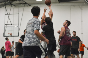 Players of two teams struggle to retain control of the ball as one team goes in for a dunk. Photo by Kyle Parks.