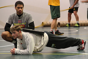 St. John during their "Power Hour" practice, cutting weight with the help of teammate Ronald Mattox. Photo by Jullianne Kay.