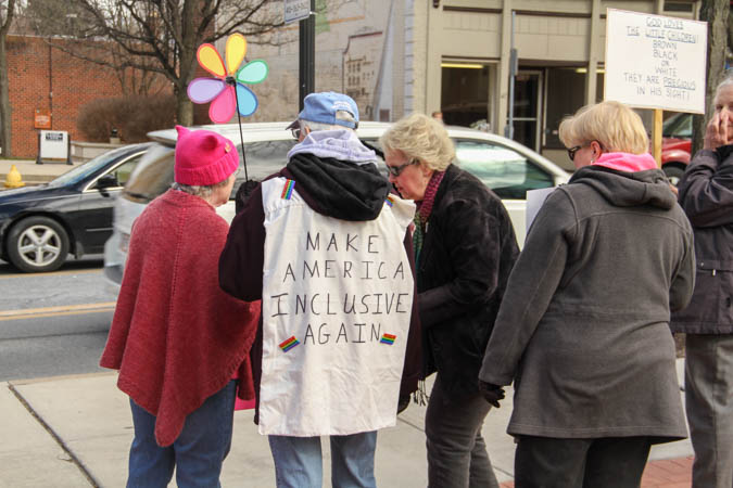 Protestors held signs and banners against the Trump Administration. Photo by Atticus Rice.