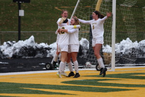 Members of the women's soccer team celebrate after the game-winning goal. (Gunnar Ward / McDaniel Free Press)