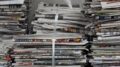 Several stacks of newspapers tied together atop one another.